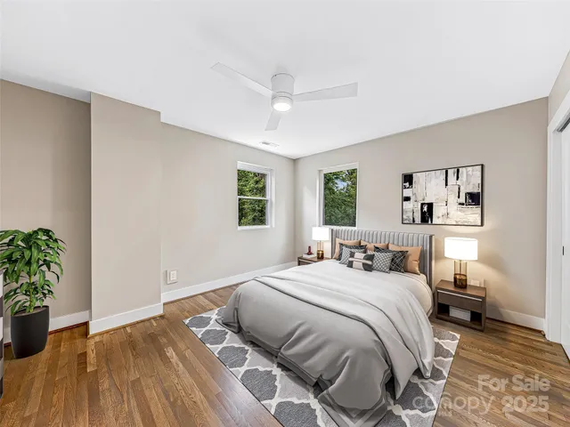 a bedroom with a large bed and a potted plant