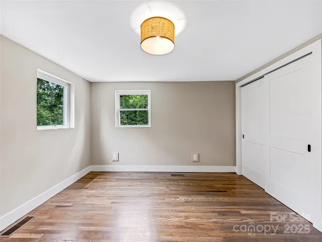 a view of room with wooden floor and window
