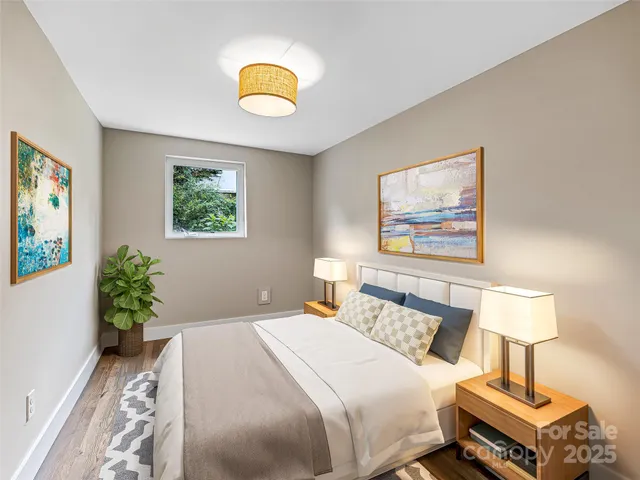 a bedroom with bed and a potted plant