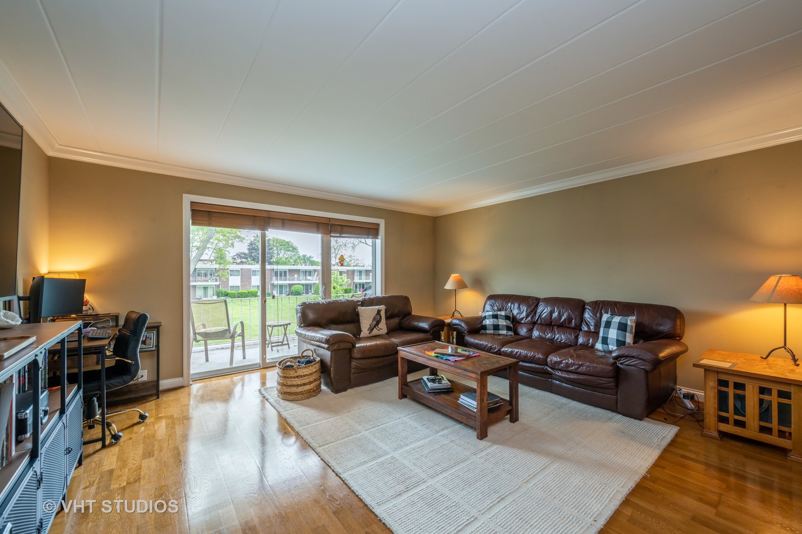 100 Deborah Lane, Unit B23 Wheeling, IL 60090 - Photo 2 of 10 a living room with furniture and a flat screen tv next to a window