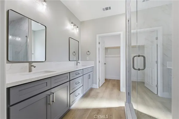 a spacious bathroom with a double vanity sink mirror double and shower