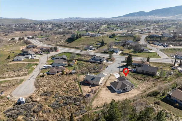 an aerial view of a houses with a street
