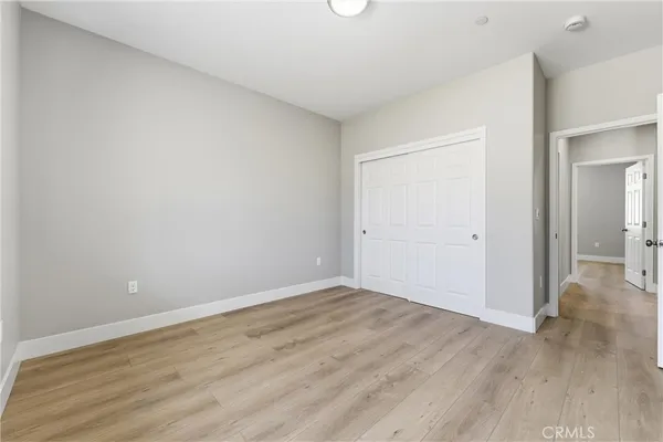 a view of an empty room and wooden floor