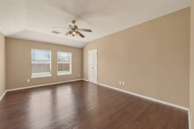 a view of room with hardwood floor and ceiling fan
