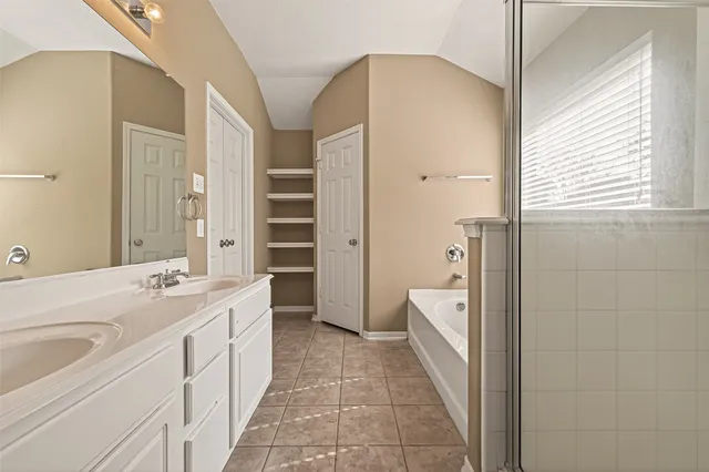 a large bathroom with a bathtub and a shower