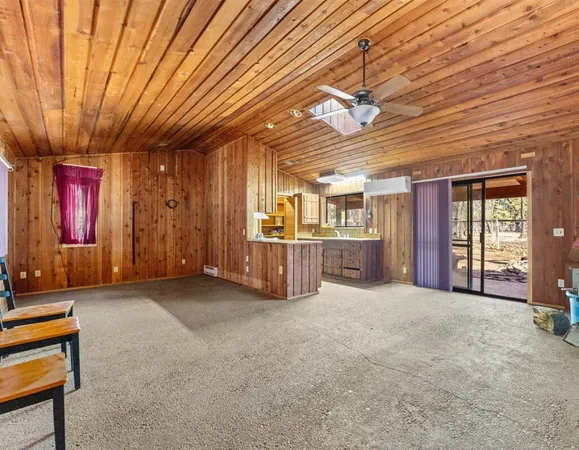 a view of a livingroom with furniture and chandelier fan