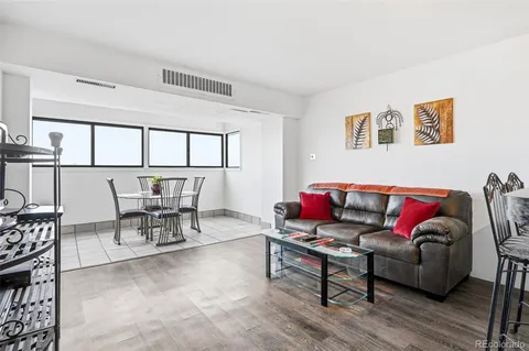 a living room with furniture and view of kitchen