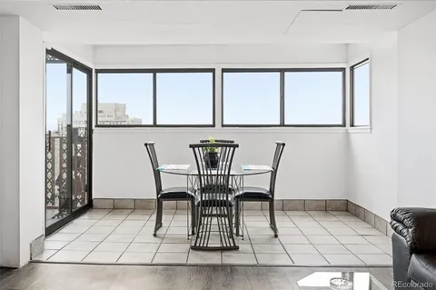 a view of a dining room with furniture and window