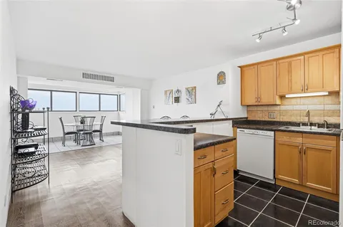 a kitchen with granite countertop a stove a sink and a cabinets