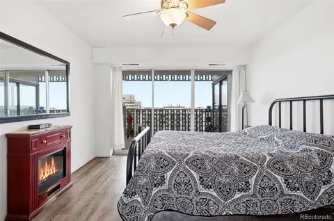 a view of a bedroom with furniture window and wooden floor