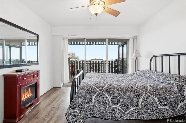 a view of a bedroom with furniture window and wooden floor