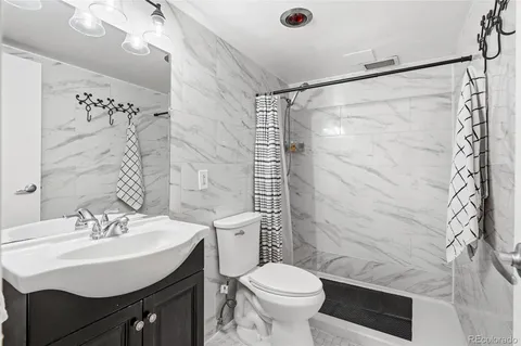 a bathroom with a sink toilet and shower