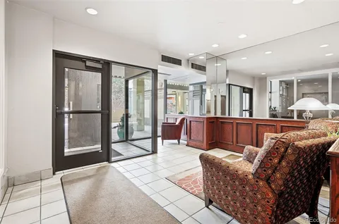 a living room with furniture a large window and flat screen tv