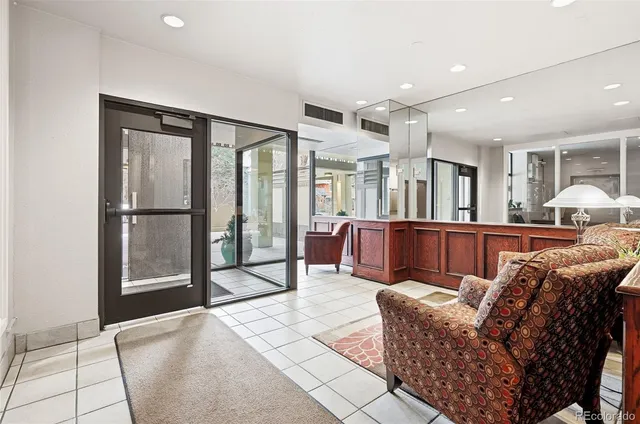 a living room with furniture a large window and flat screen tv