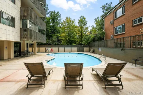 a view of a swimming pool with chair and table