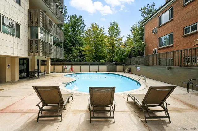 a view of a swimming pool with chair and table