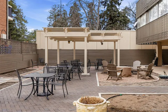 a view of a patio with a table and chairs