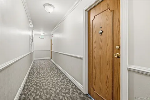 a view of hallway with wooden floor