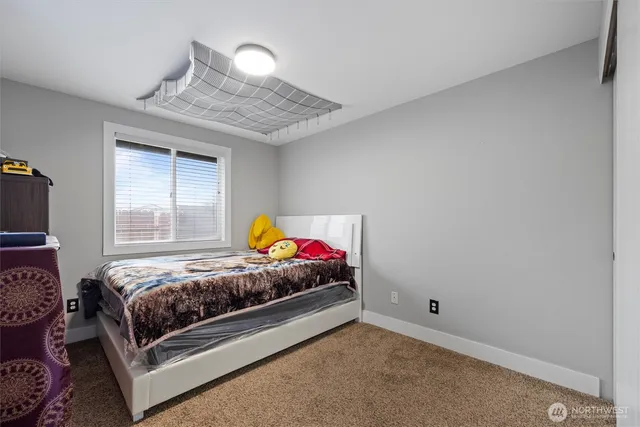 a bedroom with a bed and window