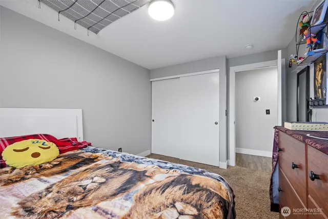 a bedroom with a bed and a closet