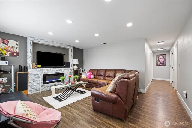 a living room with furniture a flat screen tv and a fireplace