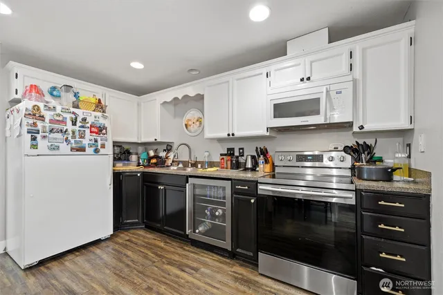 a kitchen with stainless steel appliances granite countertop a stove and a refrigerator