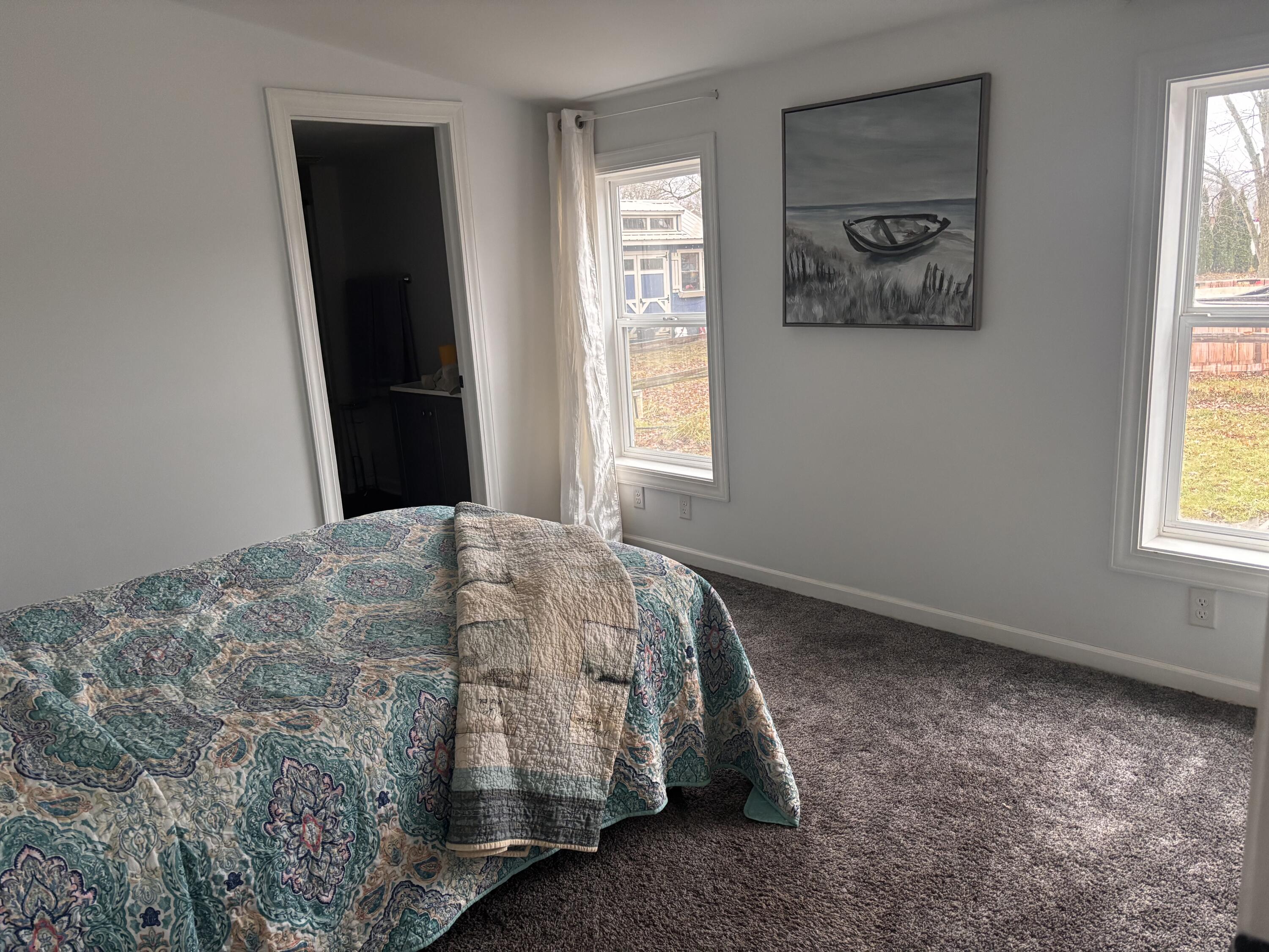 15806 Clark Street Lowell, IN 46356 - Photo 14 of 35 a bed sitting in a bedroom next to a window