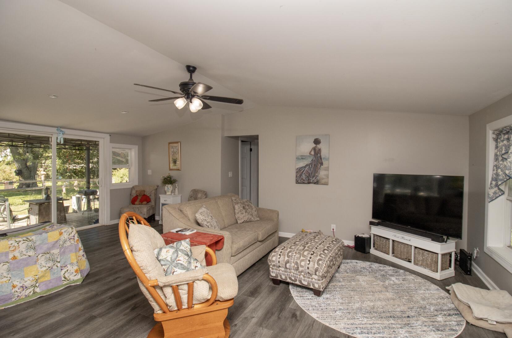 15806 Clark Street Lowell, IN 46356 - Photo 4 of 35 a living room with furniture and a flat screen tv