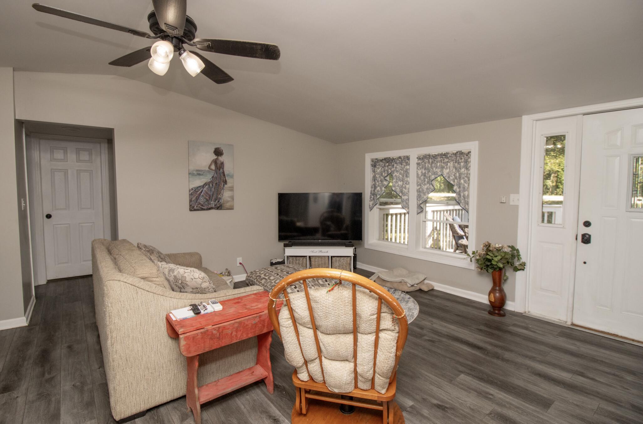 15806 Clark Street Lowell, IN 46356 - Photo 5 of 35 a living room with furniture a flat screen tv and a window