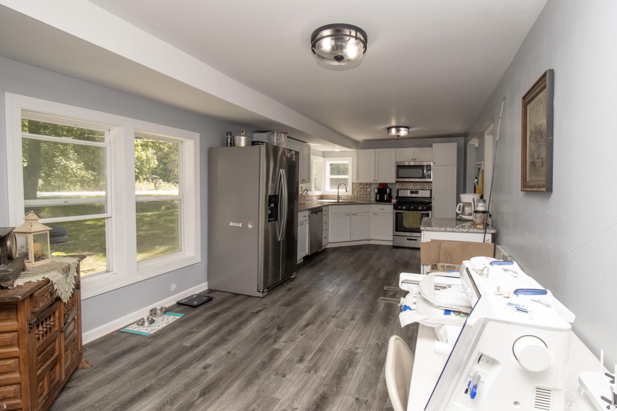 15806 Clark Street Lowell, IN 46356 - Photo 8 of 35 a open kitchen with stainless steel appliances granite countertop a refrigerator and a stove top oven