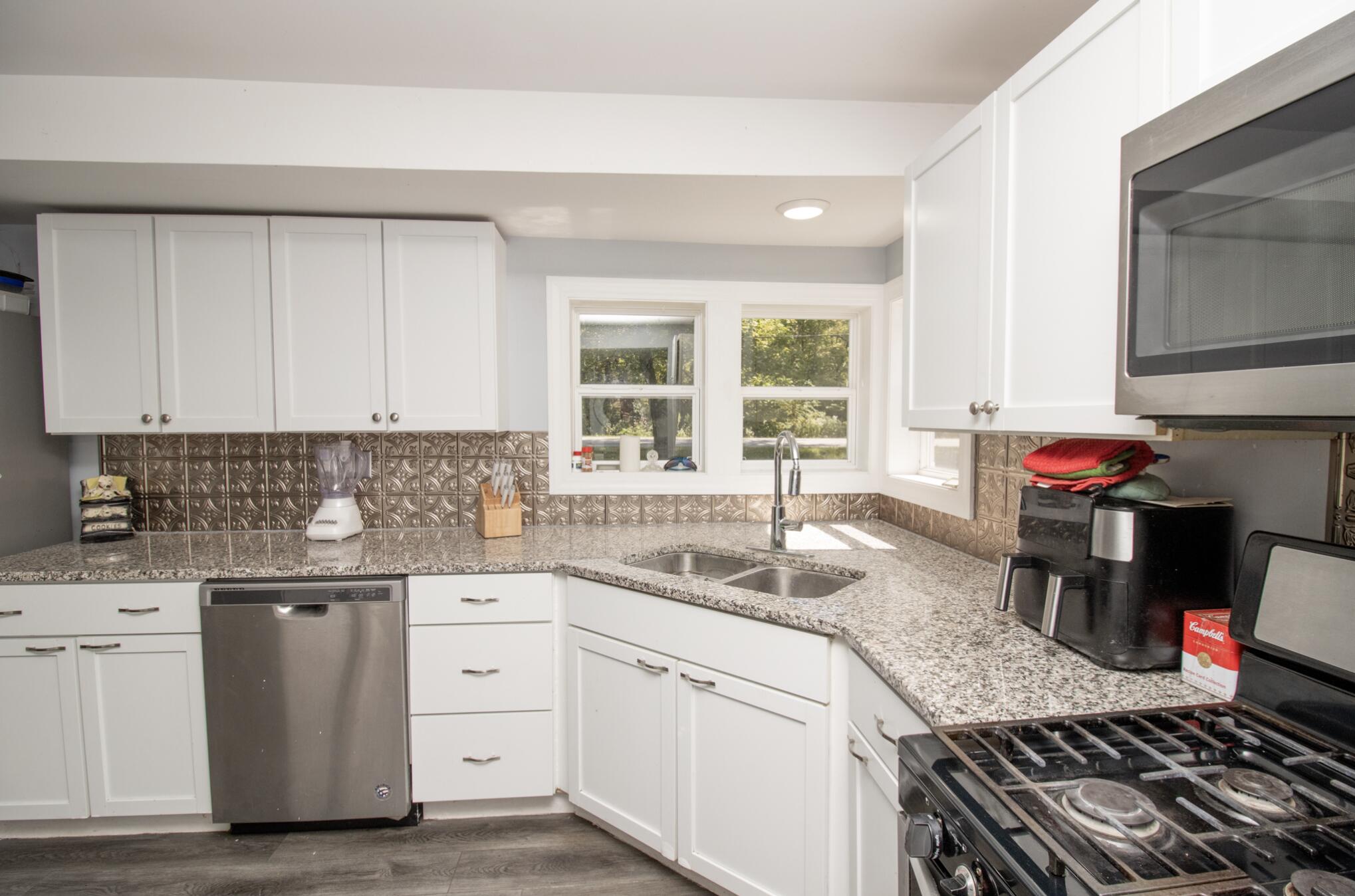 15806 Clark Street Lowell, IN 46356 - Photo 10 of 35 a kitchen with a sink stove and cabinets