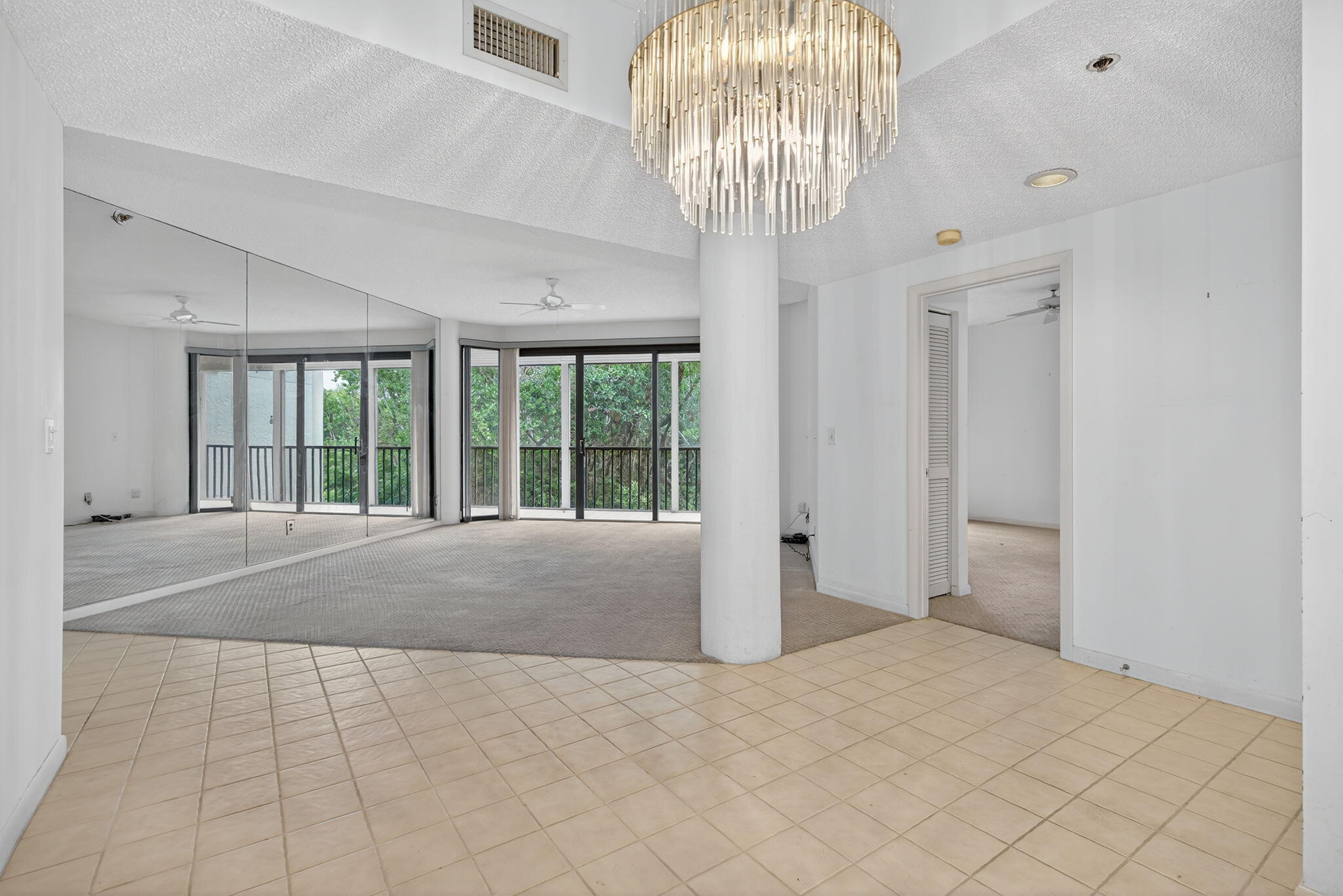 221 Northeast Plantation Road, Unit 213 Stuart, FL 34996 - Photo 15 of 44 a large bedroom with a large bed and chandelier