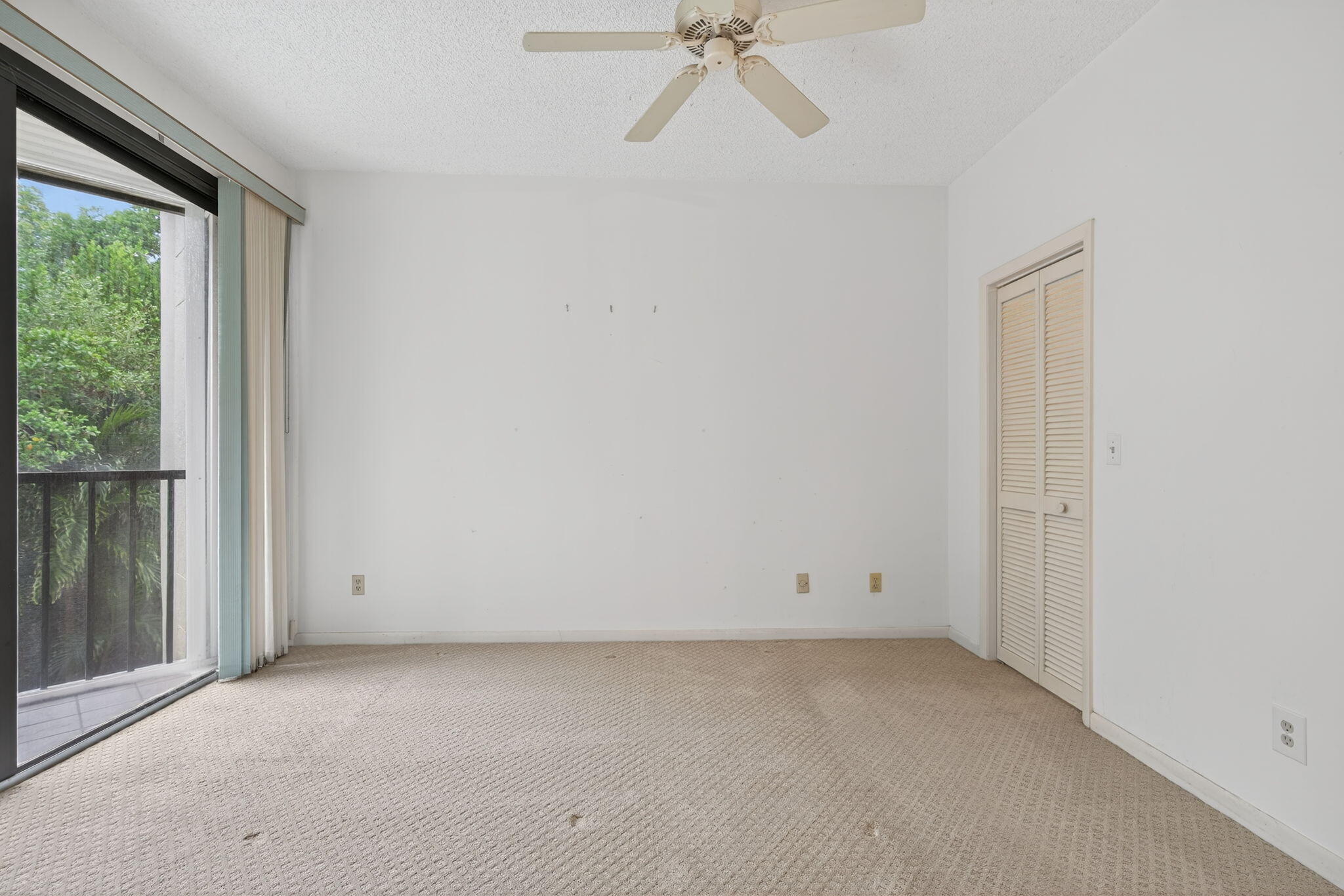 221 Northeast Plantation Road, Unit 213 Stuart, FL 34996 - Photo 19 of 44 an empty room with a white ceiling fan and window