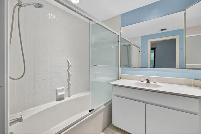 a bedroom with a large bed and a potted plant