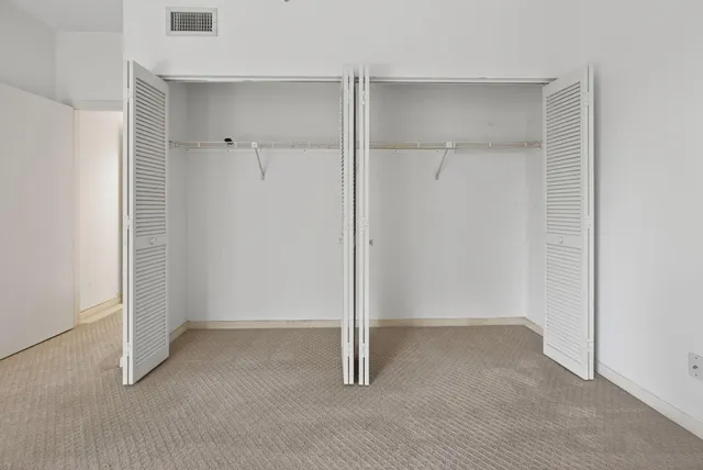 a kitchen with cabinets stainless steel appliances and a counter space