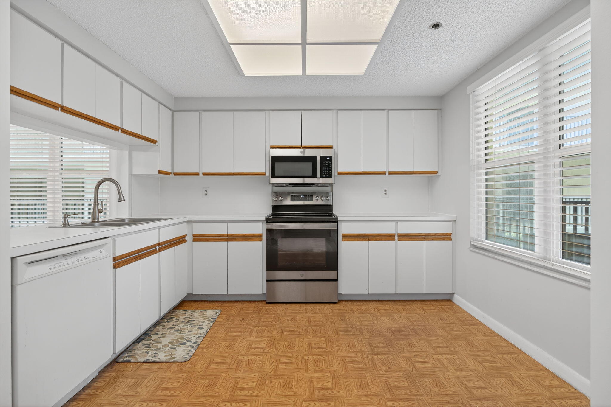 221 Northeast Plantation Road, Unit 213 Stuart, FL 34996 - Photo 33 of 44 a kitchen with granite countertop a stove sink and cabinets