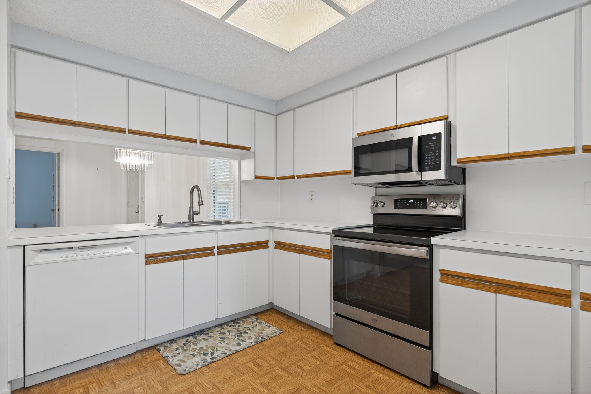 221 Northeast Plantation Road, Unit 213 Stuart, FL 34996 - Photo 35 of 44 a kitchen with cabinets stainless steel appliances and a counter space