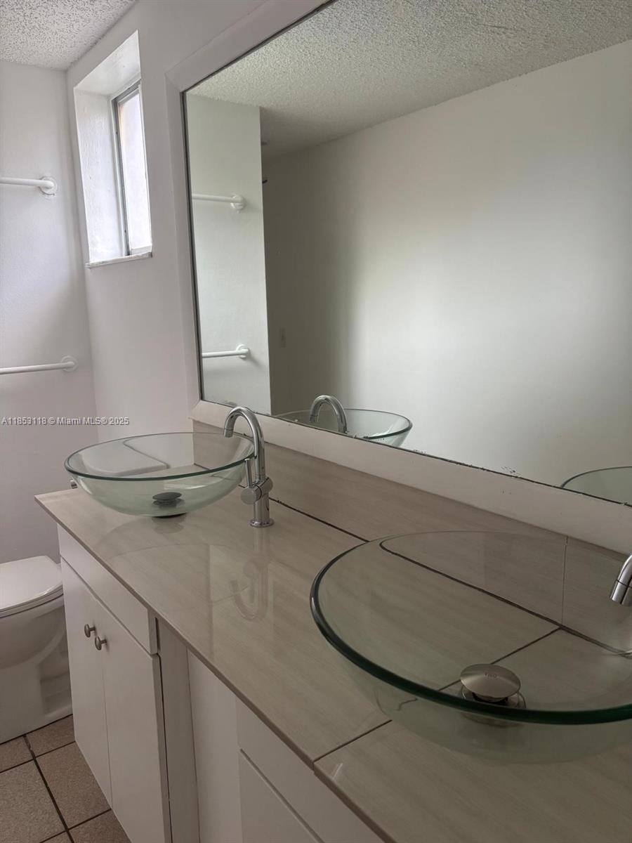 2710 West 76th Street, Unit 101 Hialeah, FL 33016 - Photo 12 of 14 a bathroom with a sink and a mirror