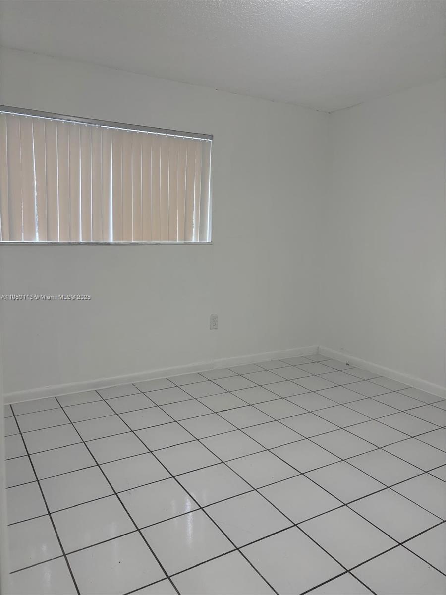 2710 West 76th Street, Unit 101 Hialeah, FL 33016 - Photo 5 of 14 a view of an empty room
