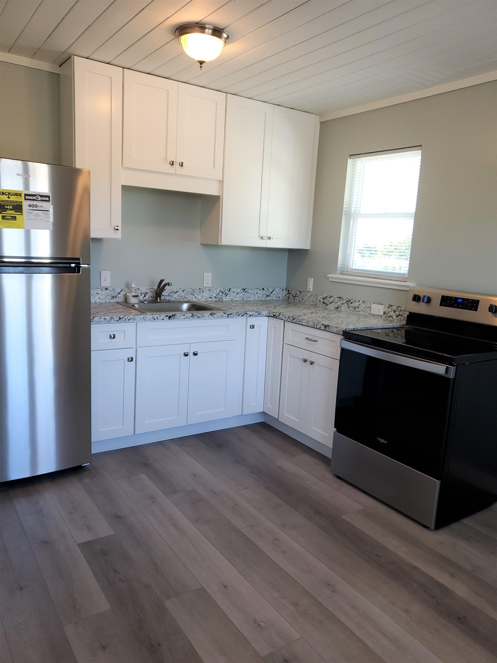 105 Beachcomber Way St. Augustine, FL 32084 - Photo 20 of 23 a kitchen with granite countertop a sink stove and refrigerator