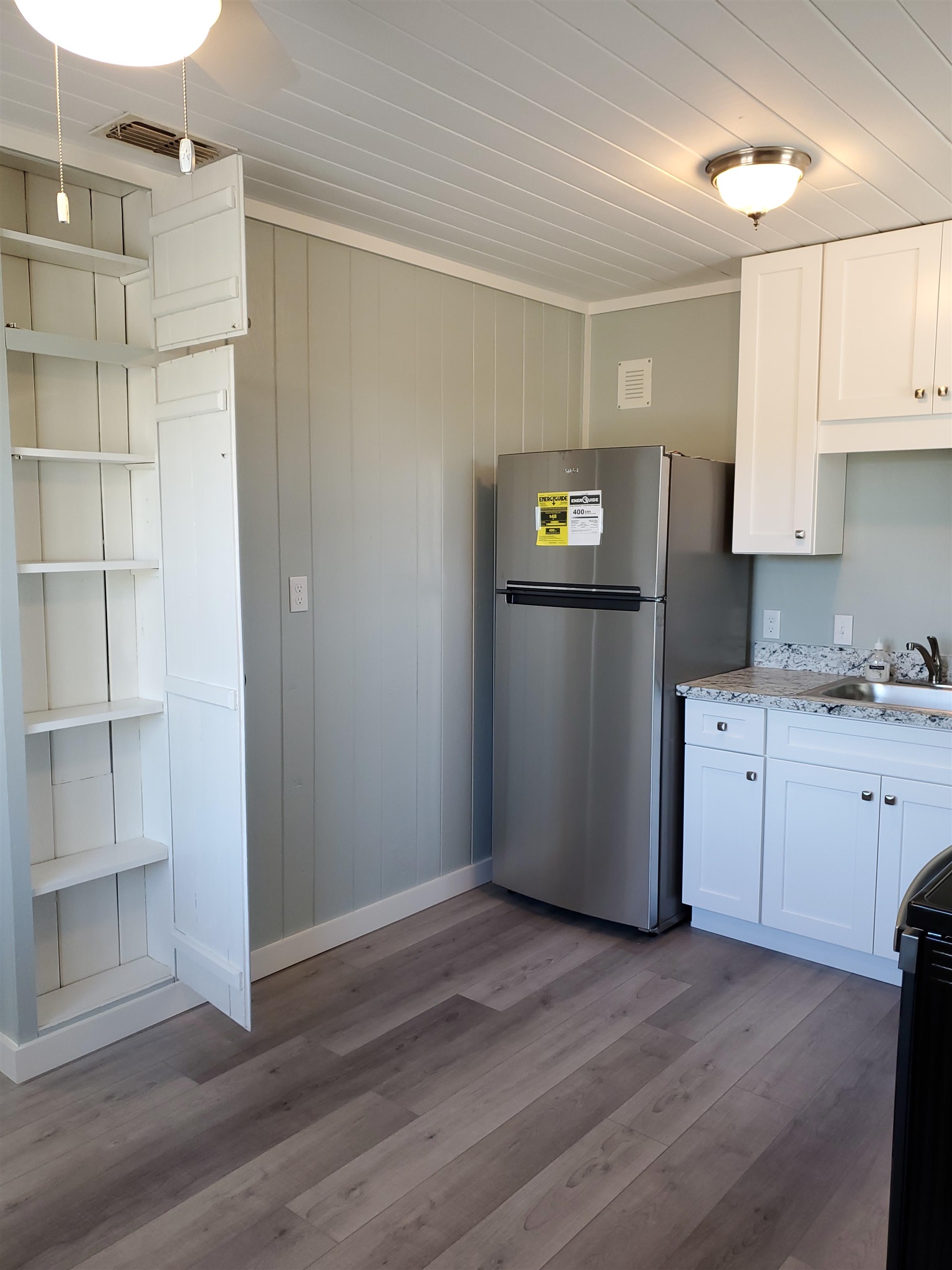 105 Beachcomber Way St. Augustine, FL 32084 - Photo 21 of 23 a kitchen with a refrigerator and white cabinets