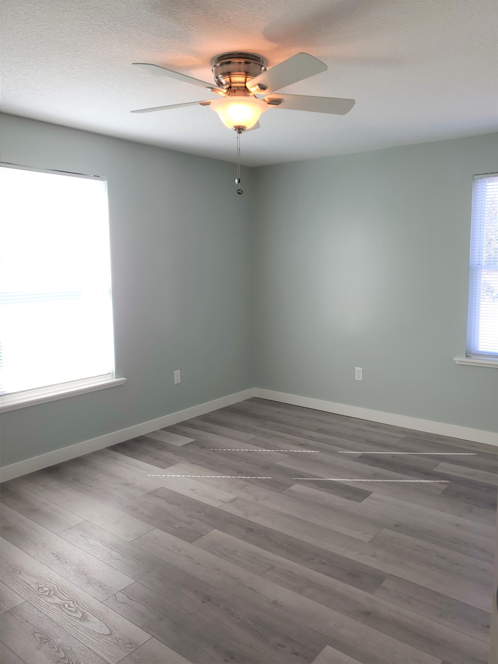 105 Beachcomber Way St. Augustine, FL 32084 - Photo 10 of 23 wooden floor in an empty room with a window