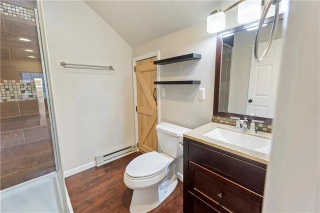 a bathroom with a sink toilet and shower