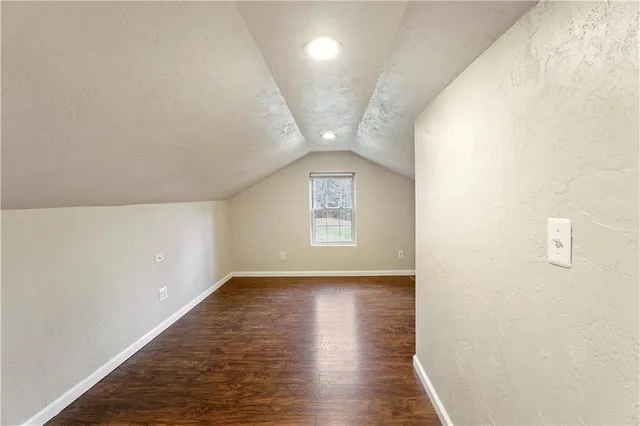 a view of an empty room and wooden floor