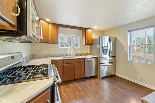 a kitchen with refrigerator and window