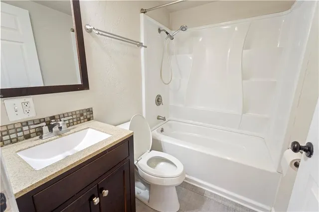 a bathroom with a sink a toilet and a bathtub