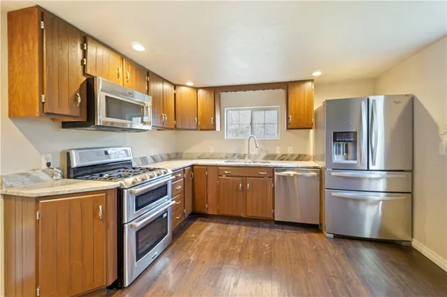 a kitchen with a refrigerator stove and sink