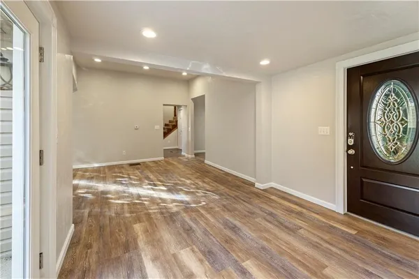 a view of room with wooden floor