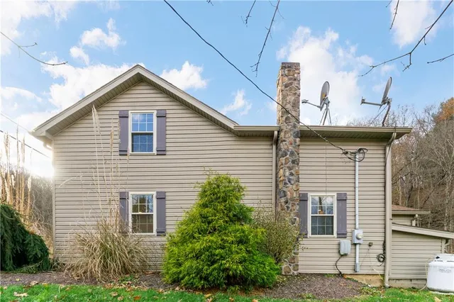 a view of a house with brick walls