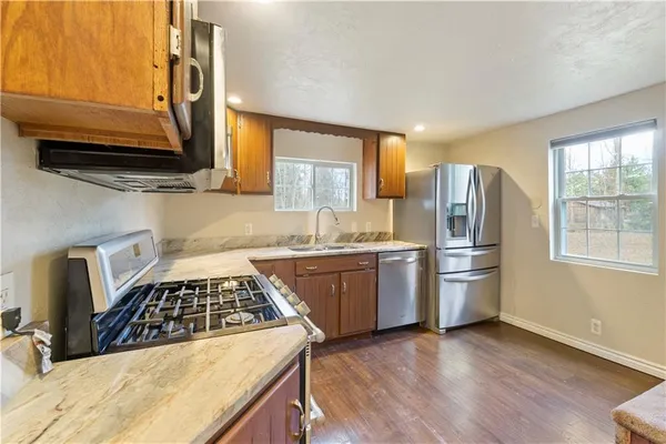 a kitchen with refrigerator and window